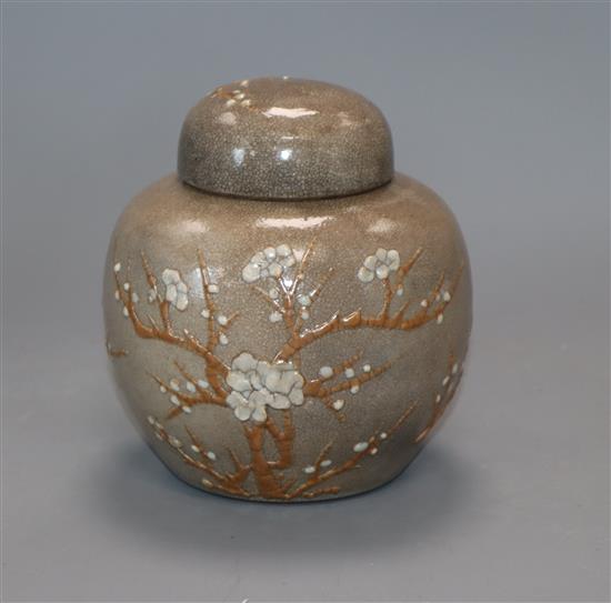 A Chinese crackle-glazed mushroom ground ginger jar and cover with prunus slip decoration